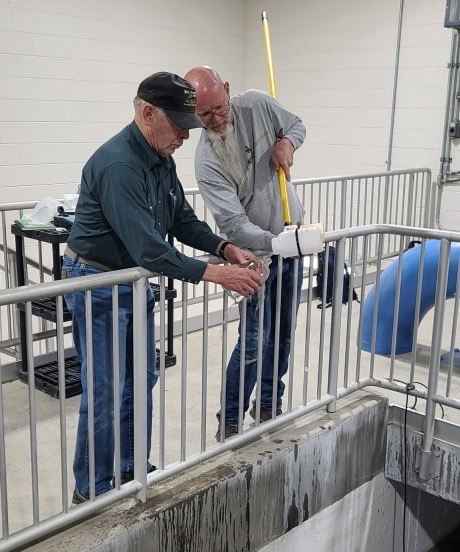 Bud Spillman and Lou Harmon of Y2 Consultants take a water sample in the pretreatment plant.